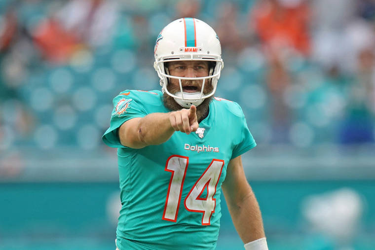 Miami Dolphins quarterback Ryan Fitzpatrick (14) looks up from the