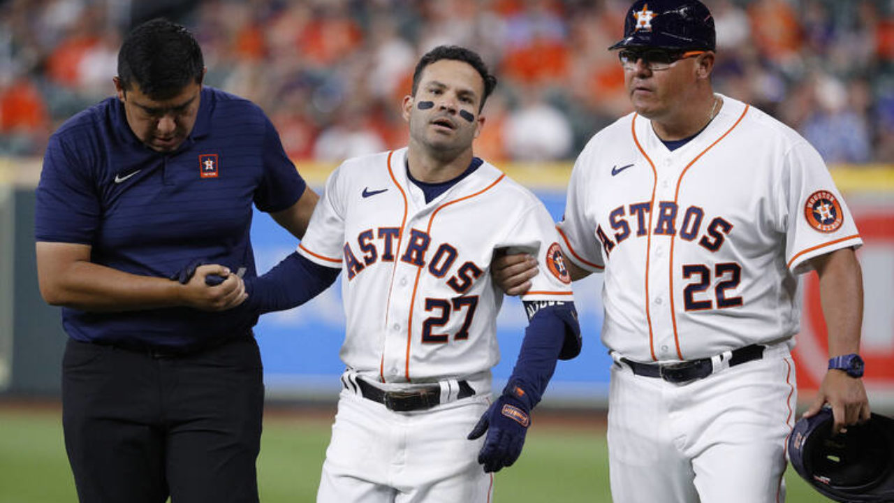 Houston Astros' Jose Altuve (R) walks with Los Angeles Angels Mike